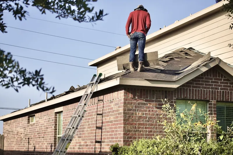 Professional roofer working on a residential roof in Boxboro Station